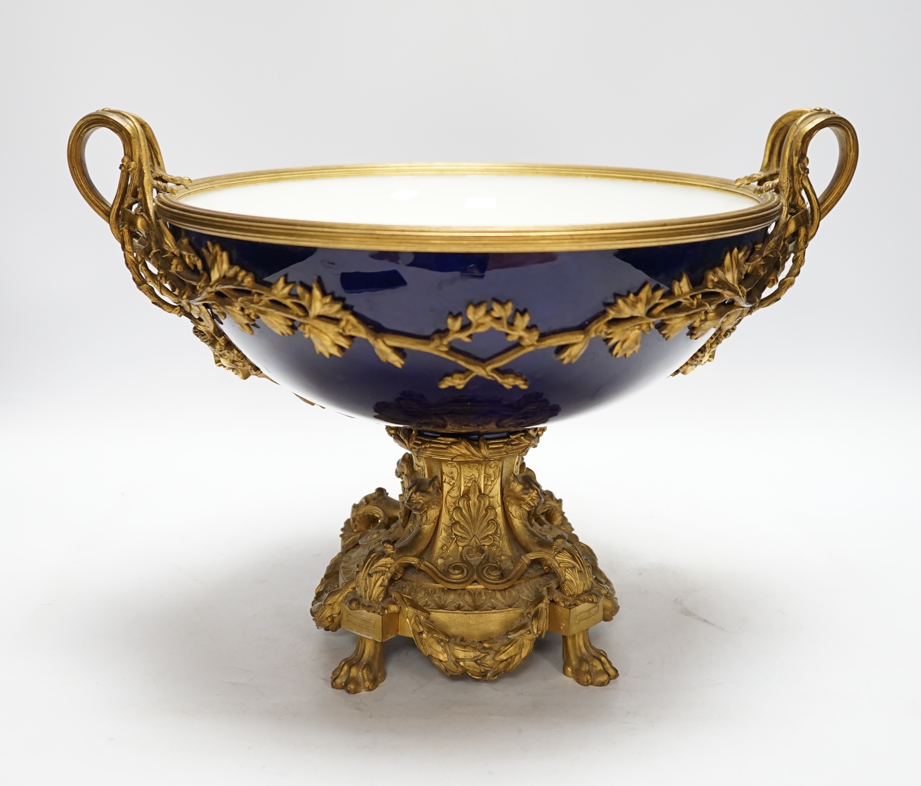 A large Louis XVI style ormolu and porcelain double handled centre dish, 27.5cm high, 31cm diameter